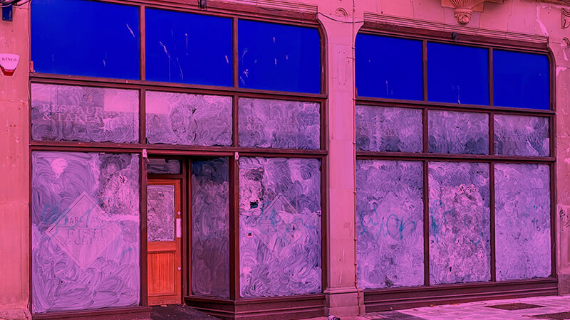 a bleak and unloved empty shop front in a UK high street