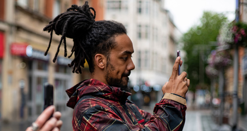 A young man with long hair interacting with Wolverhampton Street Stories