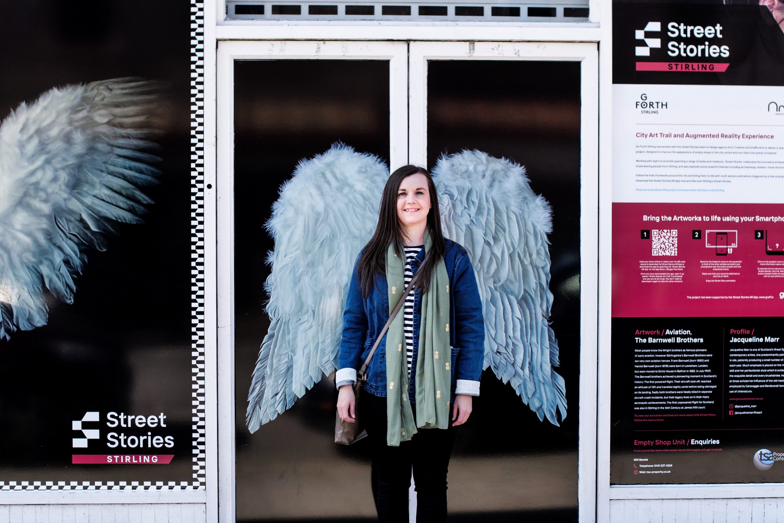 One of the artists for Street Stories Stirling stands before her artwork