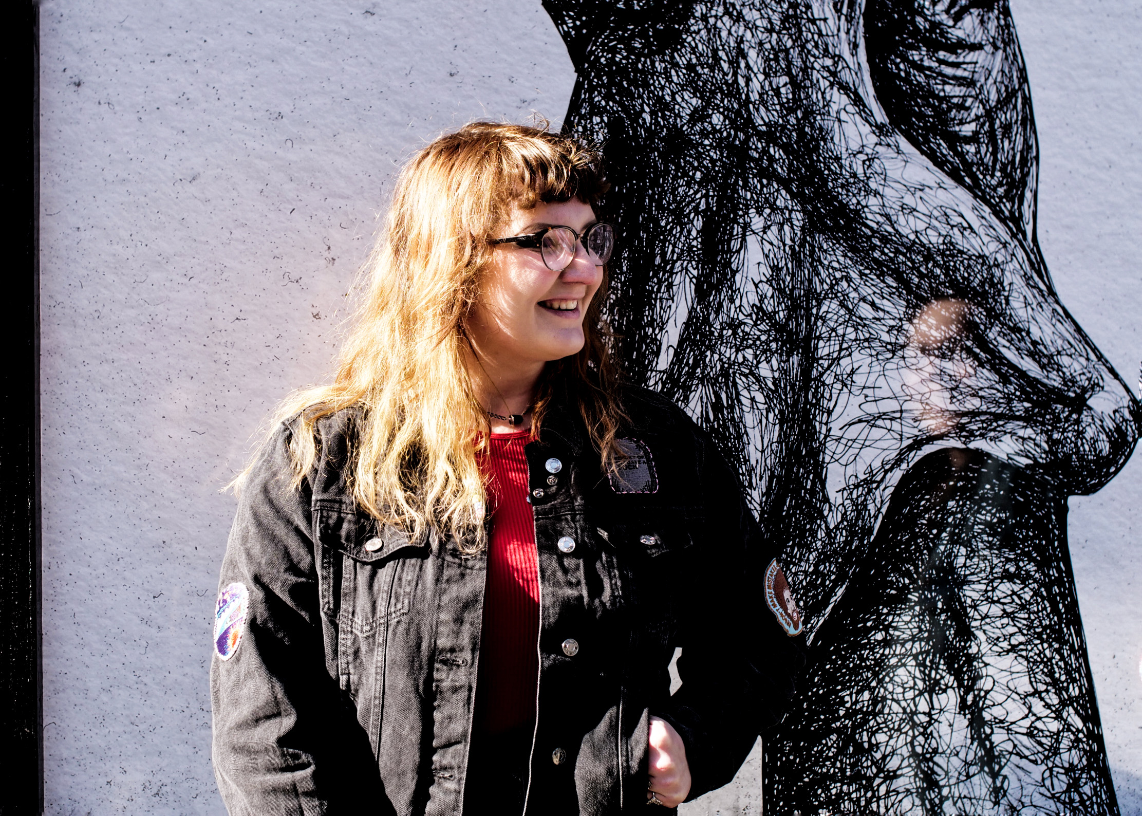 A UK artist smiling in front of her installation